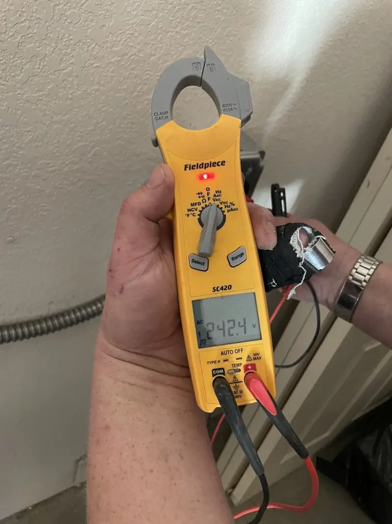 Voltage testing with clamp meter during Ceiling Fan Installation in Delhi